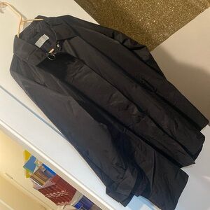 Black nylon w wool lining raincoat with silver snap buttons and details. Size M